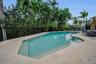 Outdoors, a beautiful, relaxing pool anchors the private backyard oasis