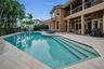 Luxury, spa-like pool surrounded by lush tropical landscaping