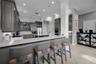 Custom cabinetry, premium appliances, expansive stone surfaces, and a generous island designed for both culinary preparation and casual gathering