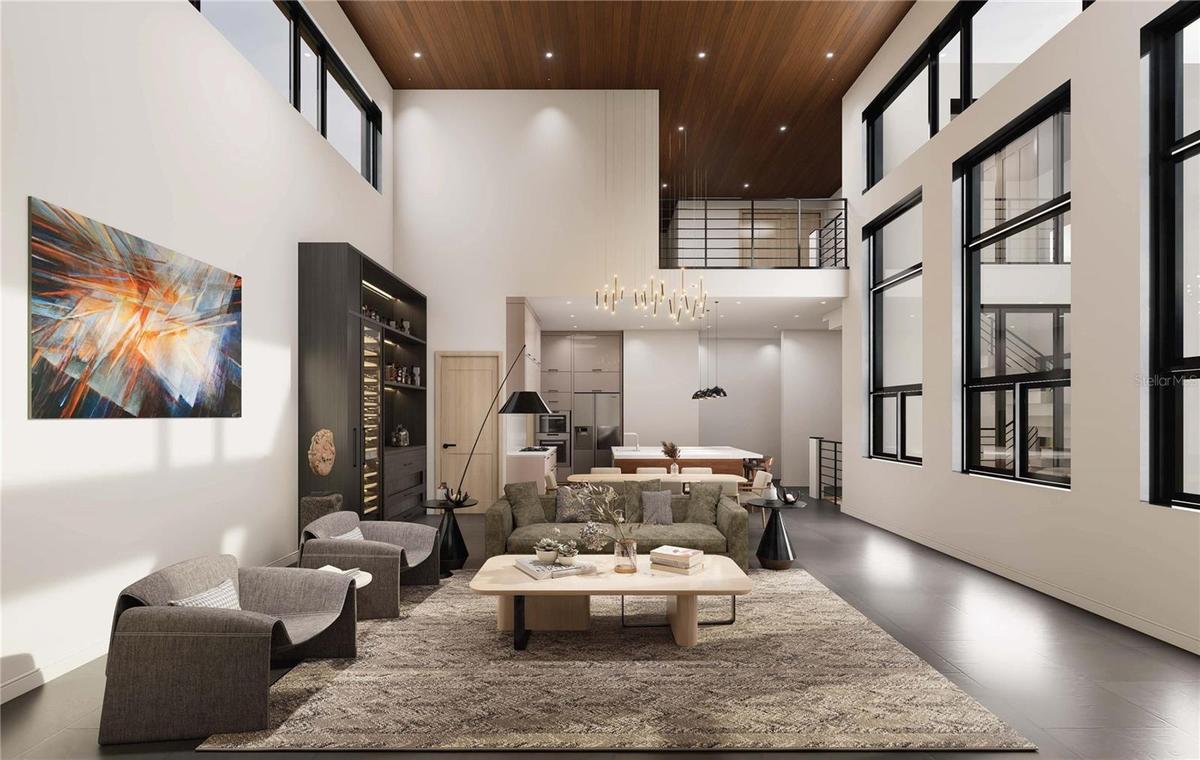 Living Room looking onto kitchen & stunning floor to ceiling windows on display to allow for maximum natural light.