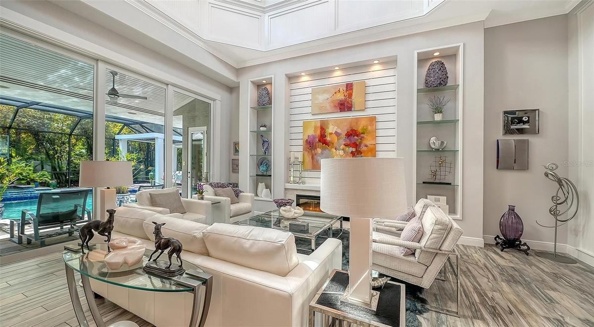 Soaring ceilings and custom millwork are features of the great room of this spectacular home