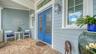 The front patio is large enough for a shaded seating area looking out over the front garden