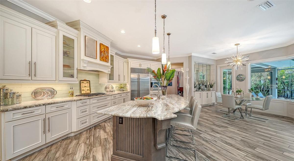 A large kitchen island, high end appliances and cabinetry are features of the kitchen, a Chef's delight!