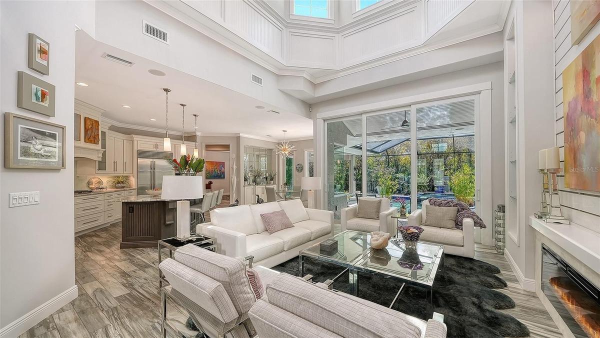An electric fireplace, 21' ceilings, and a coffered ceiling are highlights of the Great Room