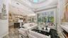 An electric fireplace, 21' ceilings, and a coffered ceiling are highlights of the Great Room