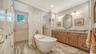 The ensuite bath delights with a soaking tub, walk-though shower, and dual sinks