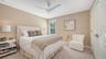 Bedroom four is carpeted, with a large closet featuring custom built-ins in each corner of the closet