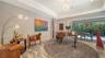 The bonus room features a disappearing wall of sliding glass doors looking out on the backyard oasis