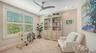 Bedroom three is at the top of the stairs.  It is carpeted and sheltered with Bahama shutters