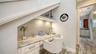 Tucked under the staircase is a handy built-in desk with granite countertop