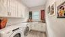 The laundry room is downstairs, just off the foyer