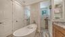 The primary suite offers natural lighting, a private lavatory, and linen closet