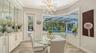 Aquarium glass windows, a custom built-in buffet, and dramatic lighting showcase the dining room