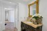 Half bathroom featuring designer vanity,gold framed mirror perfect for guests