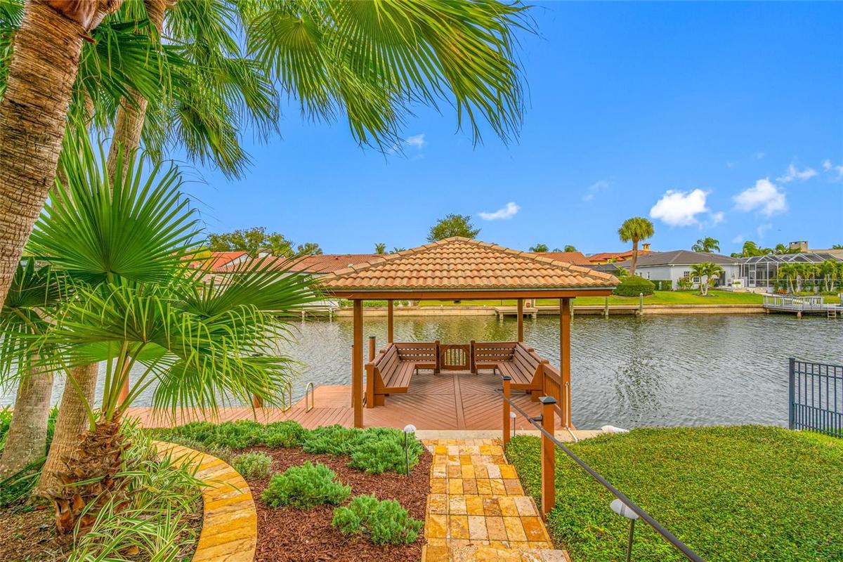 Travertine pathway to water and gazebo
