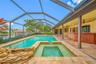 Pool and spa with waterfall and gazebo in background