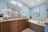 Primary bedroom custom ensuite bathroom with skylights
