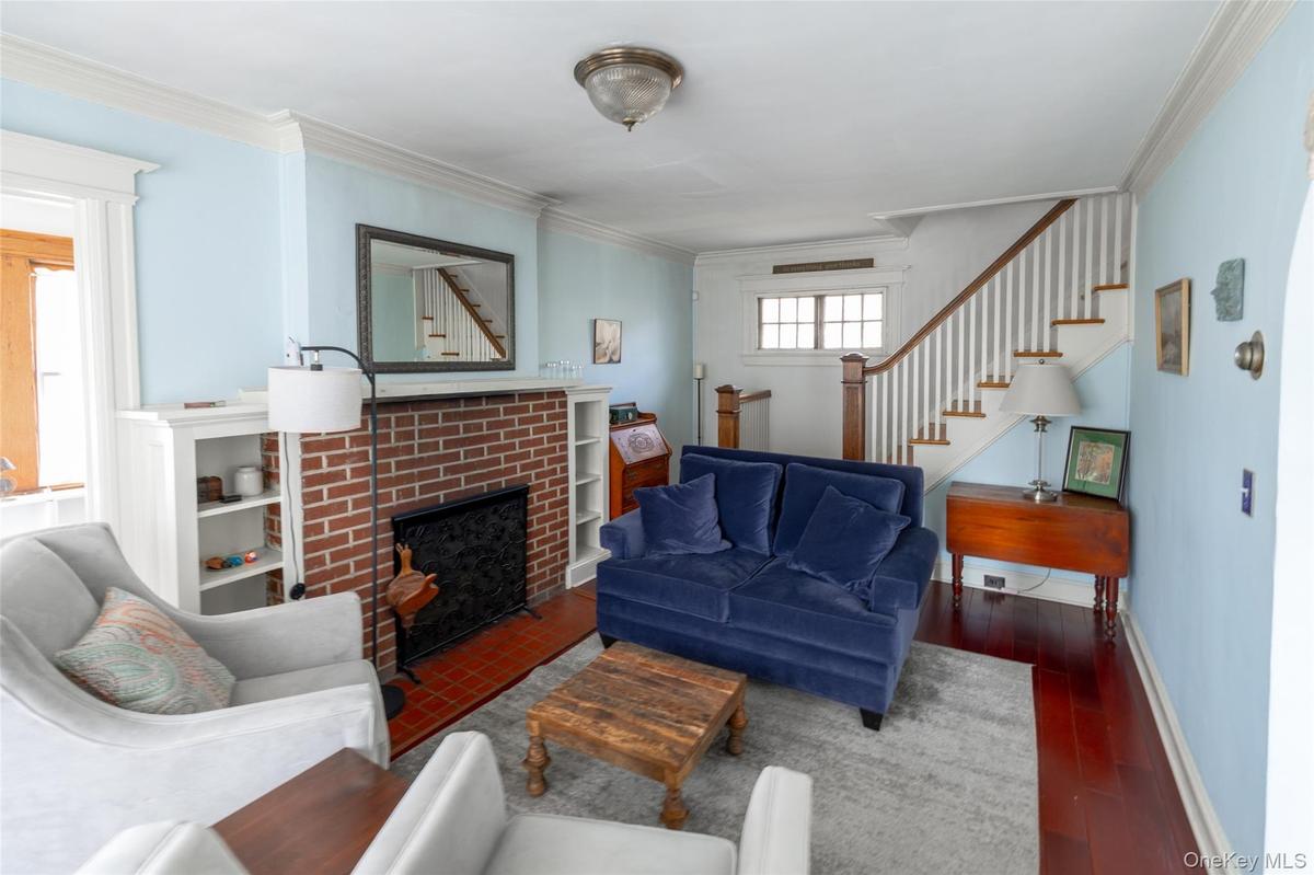 Living area featuring wood-finish flooring and a brick fireplace