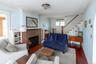 Living area featuring wood-finish flooring and a brick fireplace
