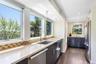 Kitchen featuring stainless steel appliances, dark wood-style flooring, decorative backsplash, plenty of natural light, and recessed lighting