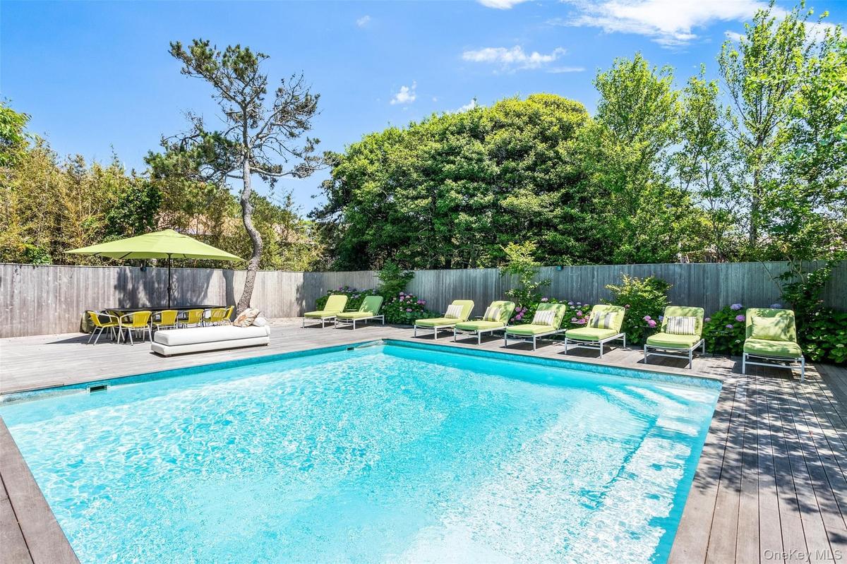View of swimming pool with a fenced backyard and a deck