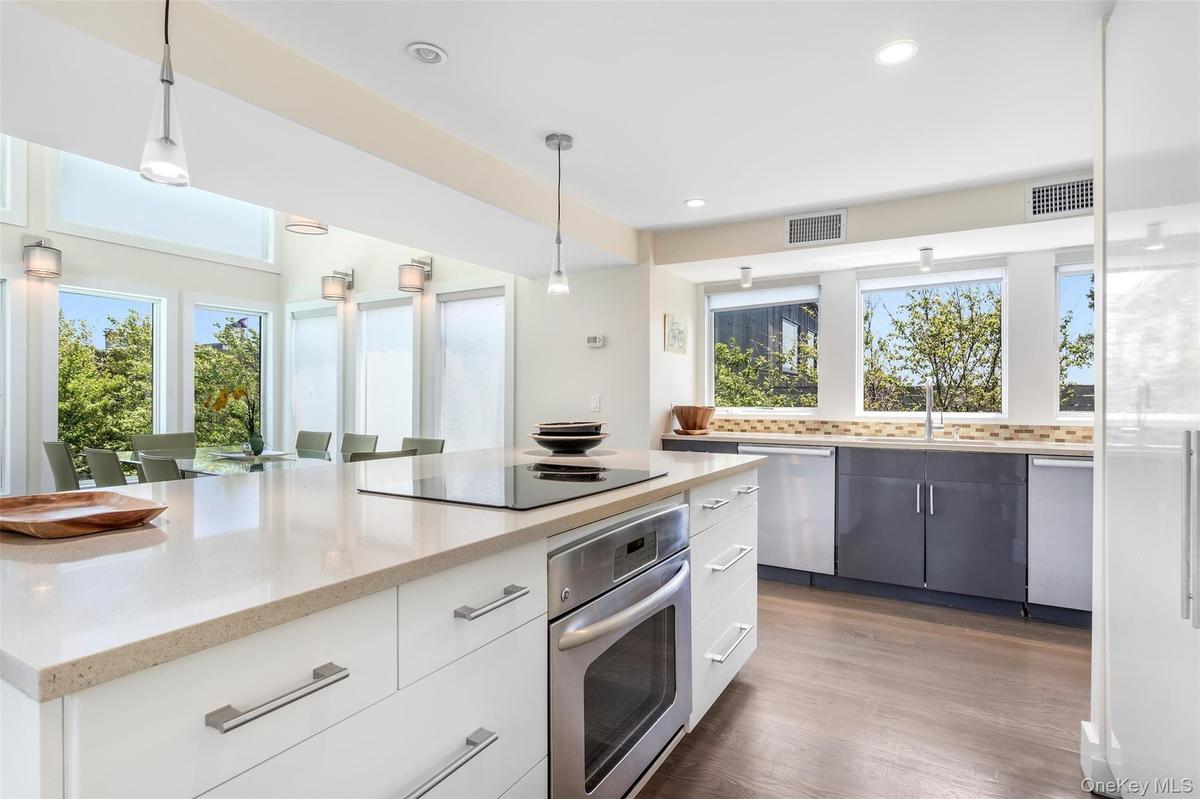Kitchen with appliances with stainless steel finishes, healthy amount of natural light, recessed lighting, and pendant lighting