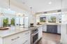 Kitchen with appliances with stainless steel finishes, healthy amount of natural light, recessed lighting, and pendant lighting