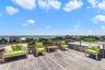 Wooden terrace featuring a water view and outdoor lounge area