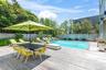 View of swimming pool with a fenced backyard, a deck, and outdoor dining space