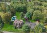 Aerial view of property's location with a pool area and beautiful private pond