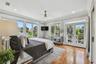 Primary bedroom overlooks the rear yard and pool area.  French doors lead to the balcony which wraps around to the entrances on the second floor of Gu
