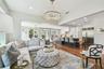 Looking from the family room towards the dining area on the left, the kitchen on the right, and the French doors in the center leading to the rear por