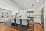 Kitchen - looking from the family room area.  Under-counter icemaker in the cabinet on the left, dual temperature wine cooler on the right.
