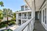 Covered porch/walkway from the primary bedroom (French doors on the right) to the two entrances in the guest wing.