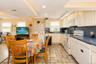 Cottage kitchen with newer appliances and white cabinets~