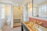 featuring a brass hammered sink and walk-in shower