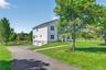 Side of the house with a spacious paved driveway.
