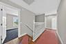 Second floor hallway with hardwood flooring.