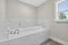 Ceramic tile flooring, walls and private window.