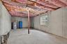 Unfinished basement area with large window.