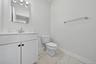 1st floor half bathroom with ceramic tile flooring.
