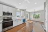 View of the kitchen and breakfast area with hardwood flooring.