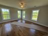 Spacious, sunny with ceiling fan + gleaming hardwood flooring.