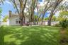 12 enormous live oak trees create a canopy over the oversized back yard, a beautiful setting for gathering all ages.