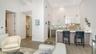 Spacious living room with dining area and seating at kitchen island.