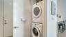 Conveniently stacked washer and dryer are ready for usage.