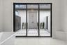 The sliding glass doors lead to the outdoor shower and private patio.
