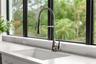 The large sink bowl sink and high-end faucet around surrounded by lots of counter top space.