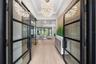 The architectural presence of the home is immediately evident as you enter the foyer through breathtaking 10-foot glass and iron entry doors.