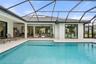 Elegant water features create a tranquil ambiance, filling the lanai with the soothing sounds of cascading water and enhancing the peaceful outdoor re